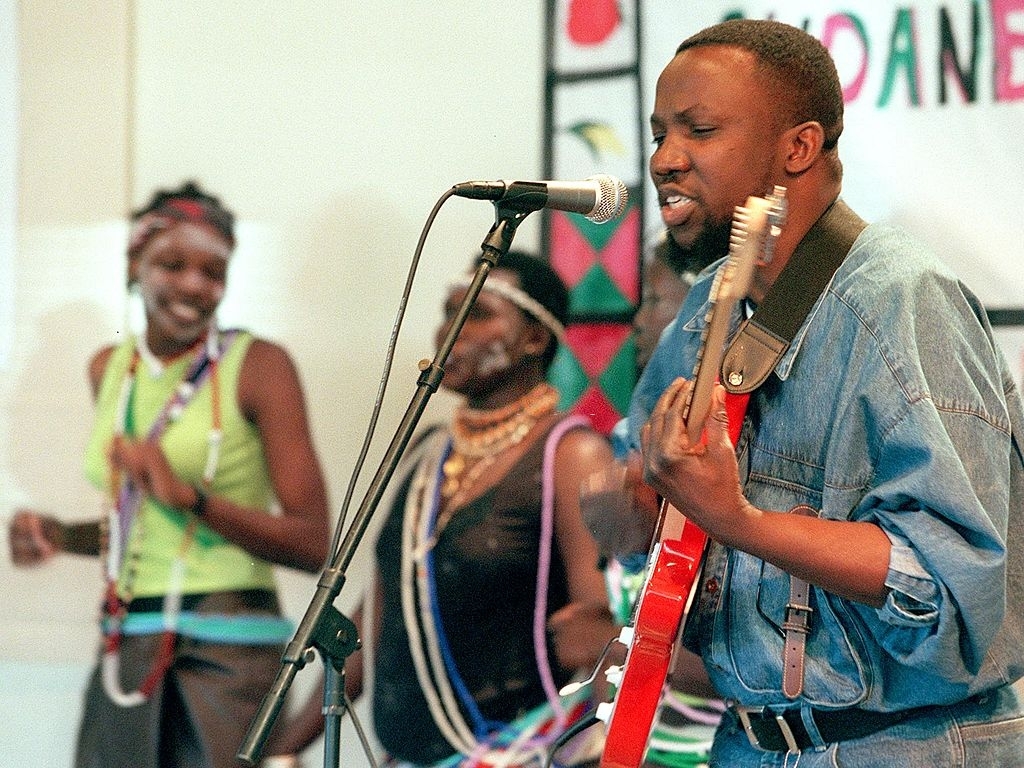 Emmanuel Kembe performing live with guitar and band