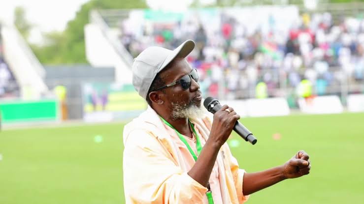 Emmanuel Kembe performing live at a stadium concert